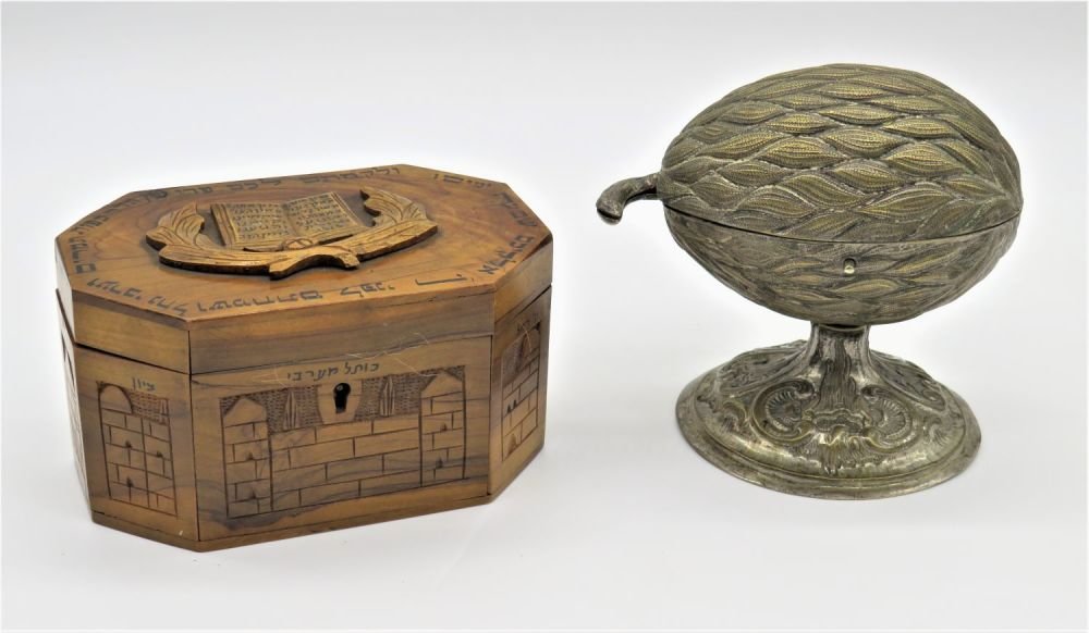 A Lot Of Two Etrog Containers, Germany And Jerusalem,: Two classic examples: the first, from Jerusalem, whose lid features a lengthy hand painted Hebrew verse discussing the blessing of the lulav and etrog. The second, from Germany, expertly cast in brass