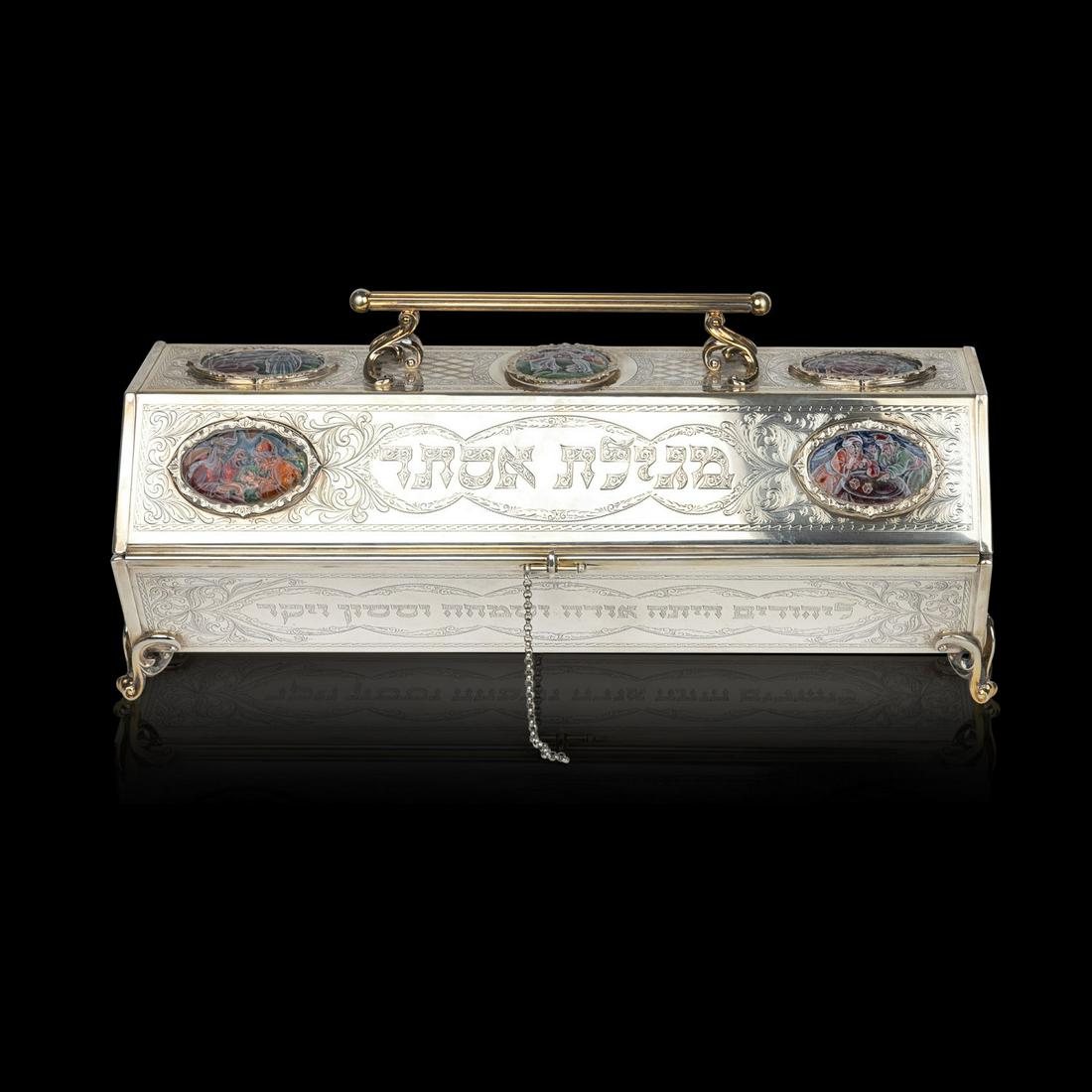 A Stunning Silver and Parcel-Gilt Megillah Case decorated with Enamel Scenes by 'Yaakov Davidoff': Hexagonal shaped case, set with seven enameled plaques depicting images from the story of Esther. Engraved with lozenge pattern and foliage design, accentuated with gold-gilt borders and supports. Ya