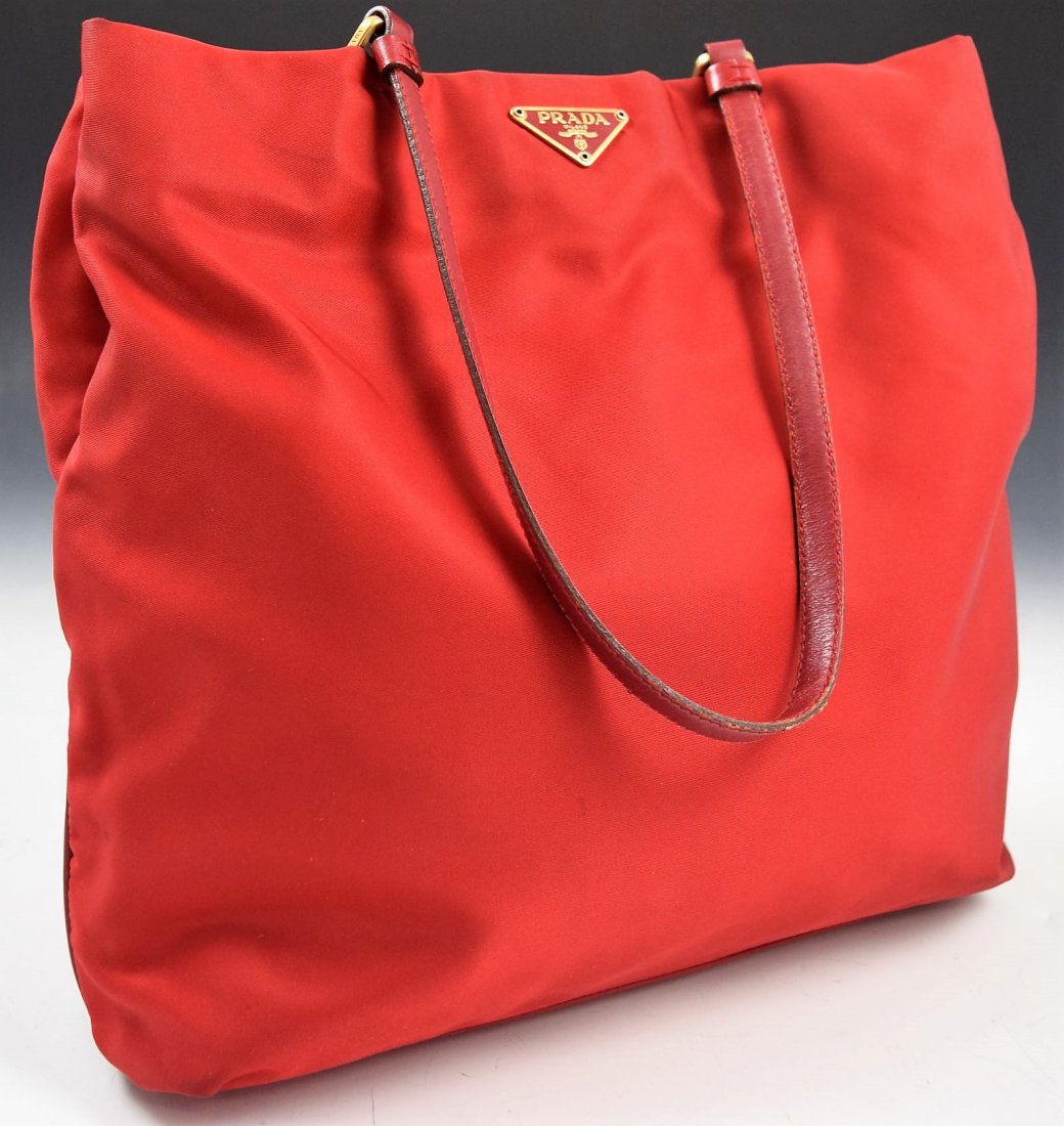 Prada Handbag: Prada issued red nylon handbag Measures: 11 x 11 x 3 inches