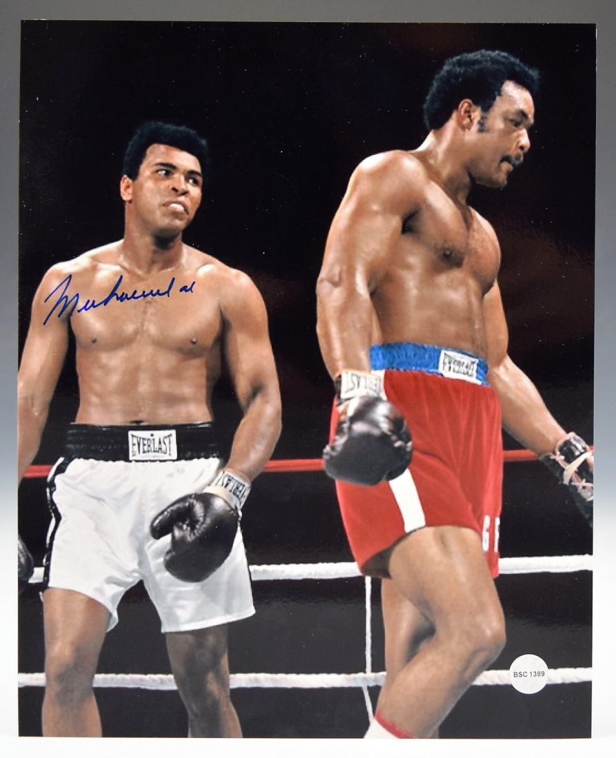 Muhammad Ali Signed Photo: A photo of Muhammad Ali signed in blue marker Measures: 8 x 10 inches COA included