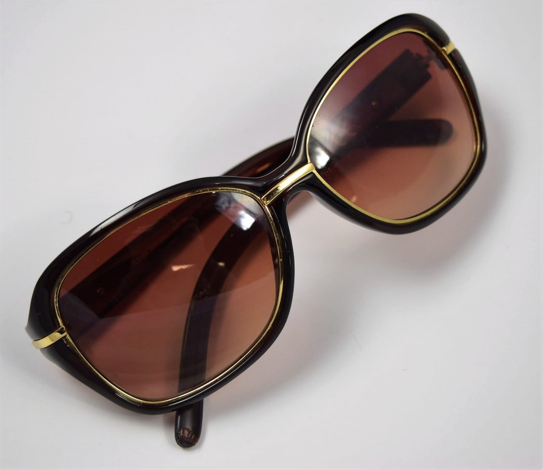 Chanel Sunglasses: Chanel issued woman's black sunglasses with gold accent
