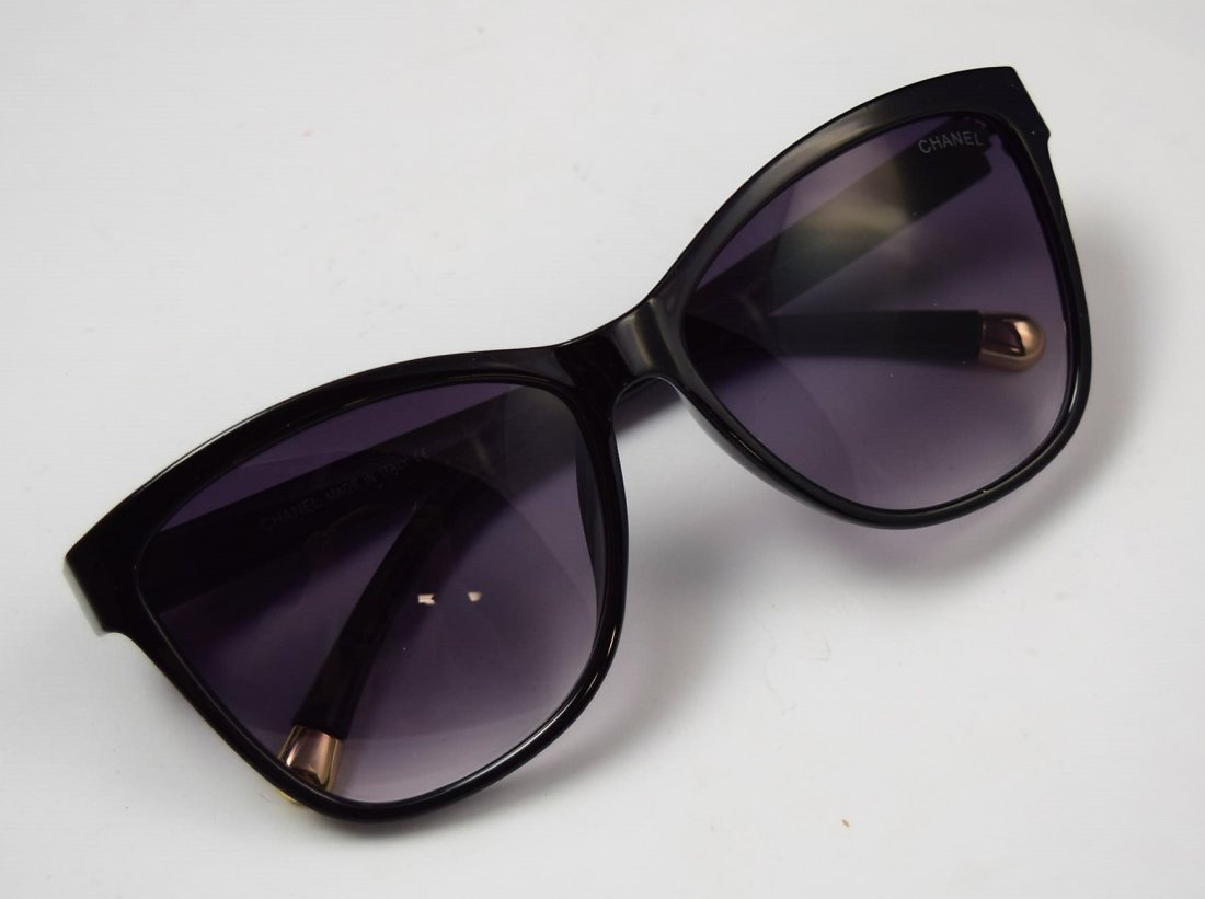 Chanel Sunglasses: Chanel issued woman's black sunglasses with gold accent