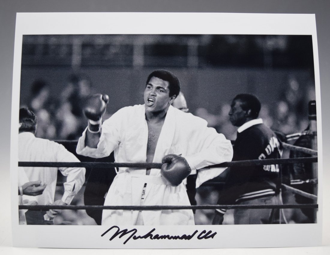 Muhammad Ali Signed Photograph: A photo of Muhammad Ali signed in black marker Measures: 8 x 10 inches COA included