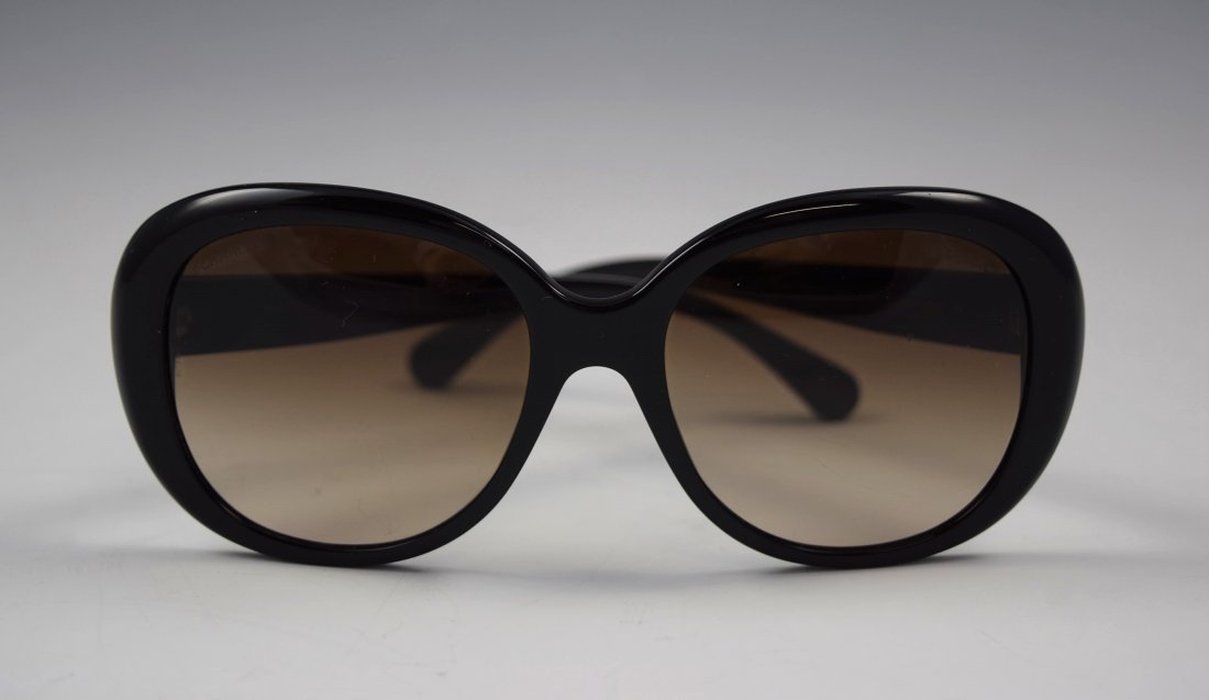 Chanel Sunglasses: Chanel issued womens black and beige sunglasses with silver accents