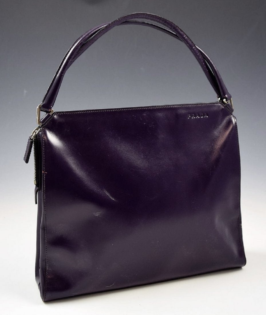 Prada Leather Handbag: Prada leather purple colored tote with silver hardware Measures: 12 x 9 inches