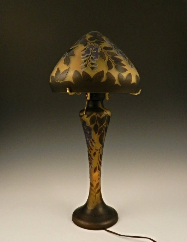 An Art Cameo Glass Mushroom Lamp: Measures: 25 inches in height Tree branches, and leafs designed with a mushroom shaped top Signed Galle on top shade
