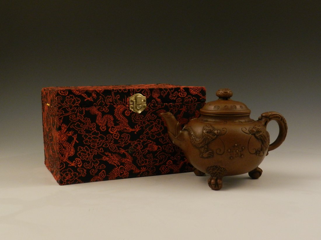 19th c. Qing Chinese Purple Sand Teapot: 6 1/2 inches in height decorated with animal reliefs and archaic patterns on the surface Three animal feet shape legs Single filler Marked Bao Rui on the bottom, qing dynasty