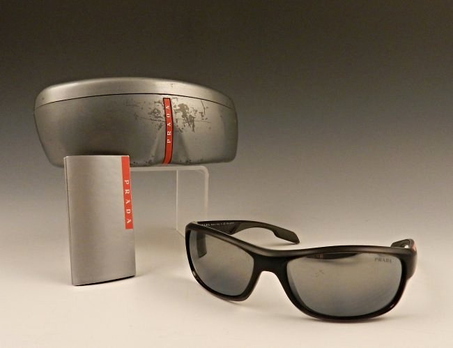 Men's Prada Black Sunglasses: Men's sunglasses by Prada, black polarized bearing red accents marked Prada Original box set and booklet included