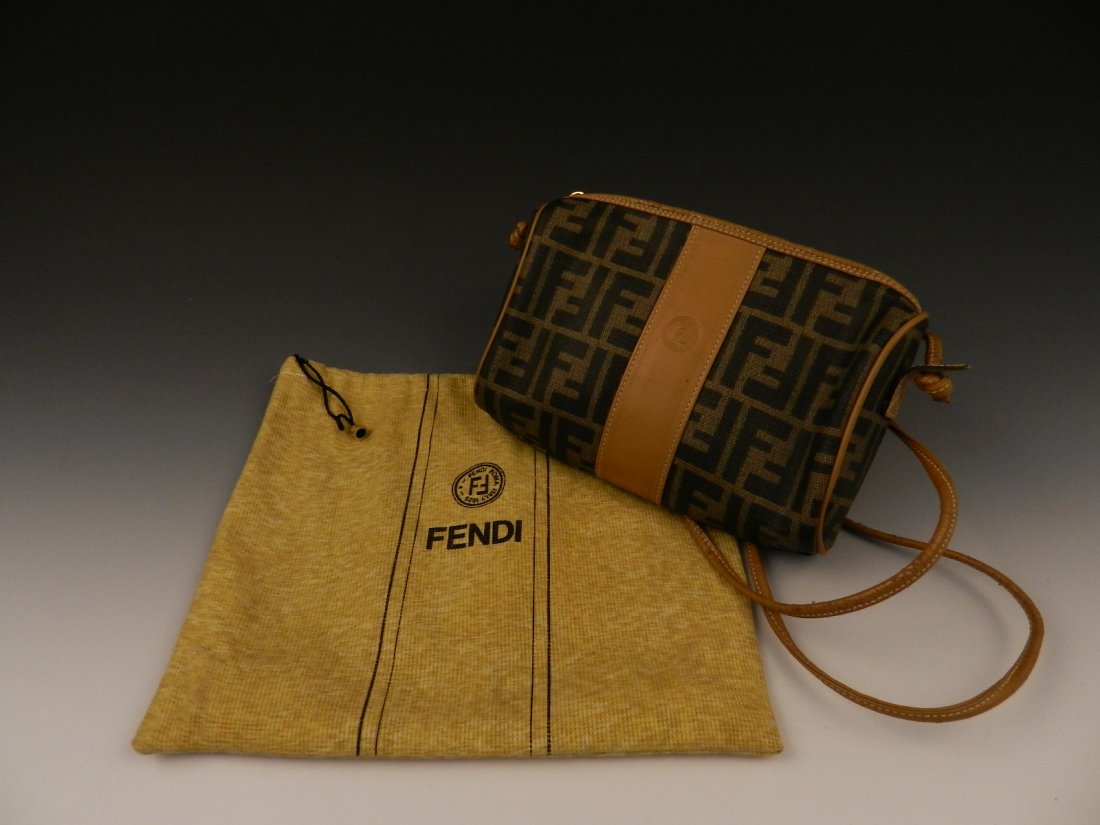 Vintage Fendi Cross body Handbag: A Fendi signature logo handbag Made in Italy Meaasures: 8 inches by 7 inches, strap length is 24 inches Original dust bag included