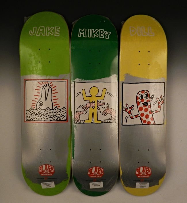 After Keith Haring Skateboard Decks: Acrylic, transfer printed plywood Set of 3 limited edition works by Haring, produced by Alien Workshop Measures: 32 inches each Each signed, & stamped from the Keith Haring foundation