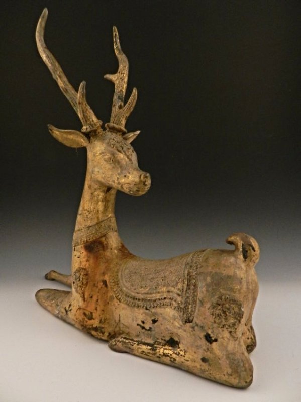 Han Dynasty Gilt Bronze Deer: A phenomenal Han Dynasty (206 BC–220 AD) gilt bronze sitting deer with its head turned and one leg tucked in Measuring: 22 x 22 inches in full size From an important private estate collection, PA. T