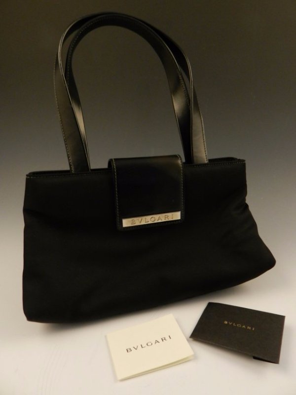 Bulgari Black Leather Bag: Black leather and nylon Bulgari handbag Measures: 11 x 7 inches, 8 inch drop Comes with original Bulgari cards