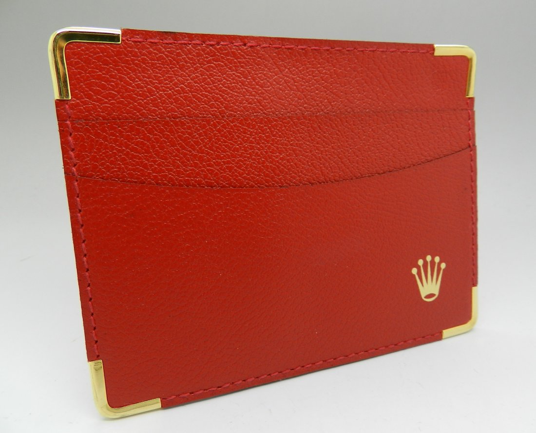 Rolex Red Leather Wallet: A brand new red and gold Rolex issued wallet/credit card holder Measures: 4 1/2 x 3 1/2 inches