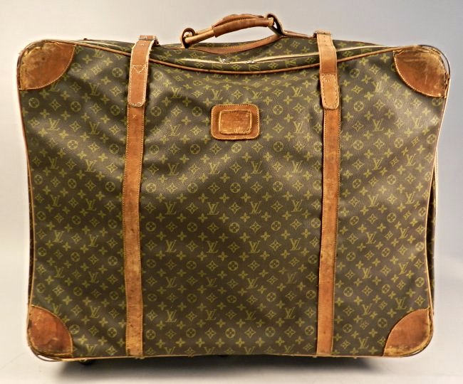 Louis Vuitton Suitcase: A brown leather Vuitton suitcase, antique circa 1925 Measures: 30 x 23 x 11 inches Lot note: This bag was once owned by Judge Judy and was given to the previous owners family by her directly.