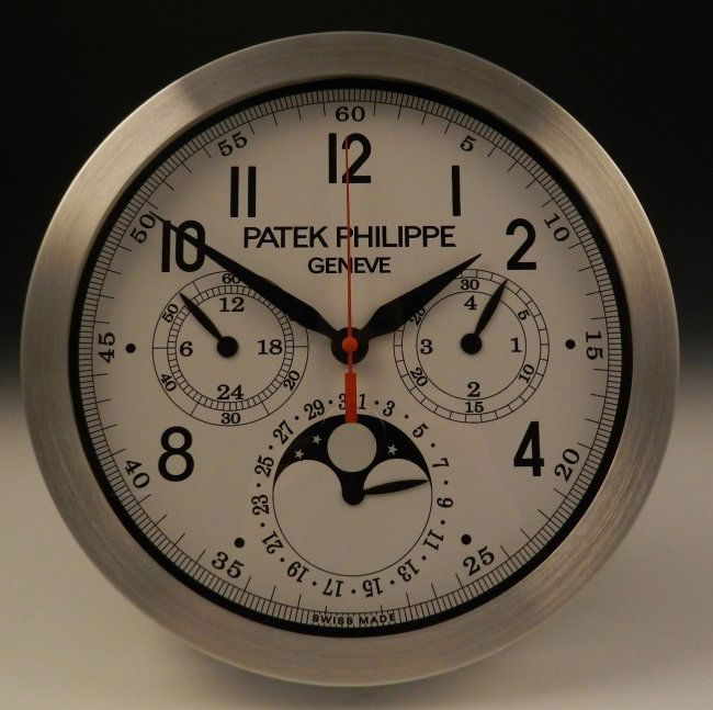 Patek Philippe Showroom Dealer Clock: Dealer showroom clock, Patek Philippe Clock is battery operated, stamping to backside Measures: 12 inches