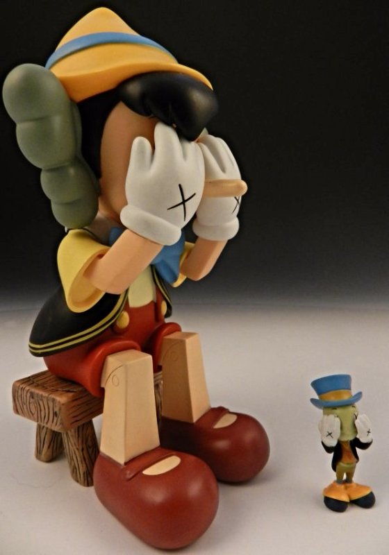 Kaws Sculpture: Cast vinyl figure of Pinocchio and Jiminy Cricket Two limited edition works from Medicom Original box included