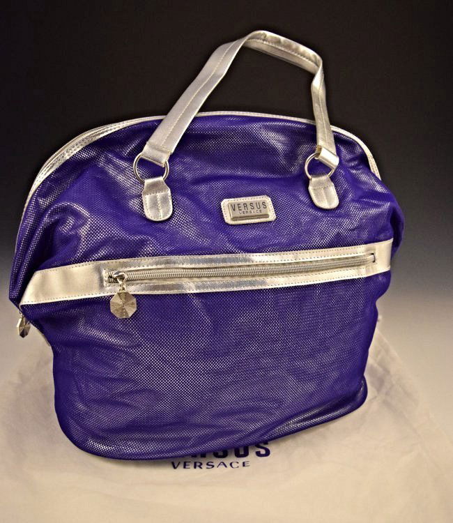 Versace Purse: Versace issued purple and silver purse Measures: 22 inches in full length, bag size: 14 x 14 inches