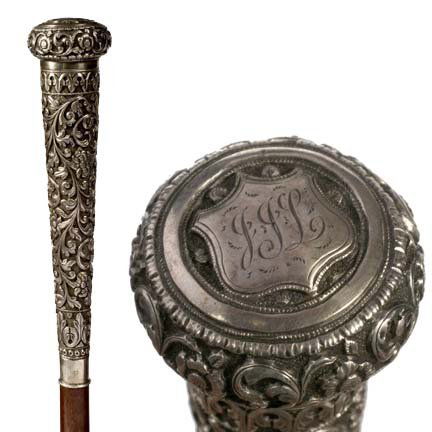 Asian Silver Dress Cane-C. 1895-Handchased and eng: Asian Silver Dress Cane-C. 1895-Handchased and engraved in high relief, this handle has scrolling foliage and flowers with a long tapering stem, rich hardwood shaft and a brass ferrule-H. 6 ½" x 1 ½