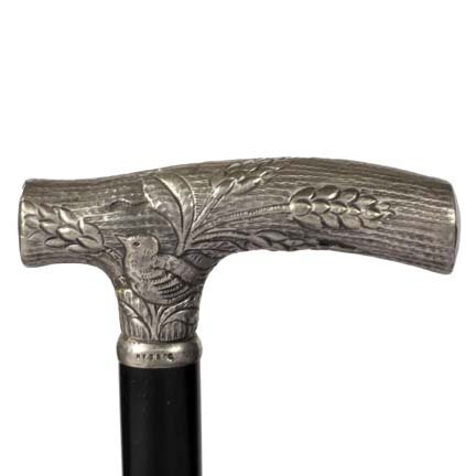 Opera Silver Dress Cane-C. 1880-The handle has the: Opera Silver Dress Cane-C. 1880-The handle has the Simmons signature and trademark and is also signed sterling. It has an ebony shaft and a bi-metal ferrule-H. 3 ½" x 1 ¾", O.L. 35"-$150-$250