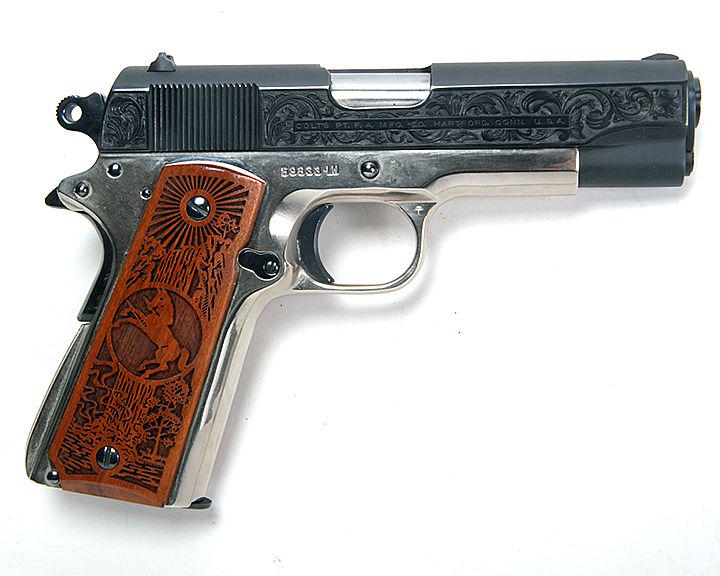 Colt 1911 Combat Commander 45 cal, blue slide, nickle: Colt 1911 Combat Commander 45 cal, blue slide, nickle frame, slide is factory engraved, relief carved factory wood grips, 4" barrell, no paperwork and aftermarket case