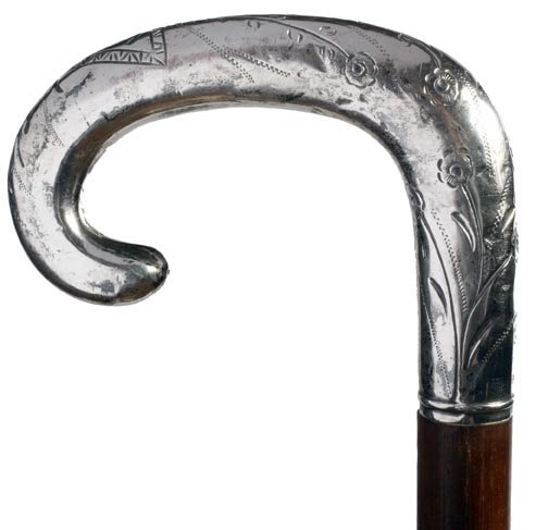 Silver Dress Crook Cane: Silver Dress Crook-Circa 1885-A hand engraved handle with flowers and foliage, Malacca shaft and a two piece ferrule which has a signature of Isaac Smith-H. 3 ½" x 2 ½", O.L. 34 ½-$300-$500