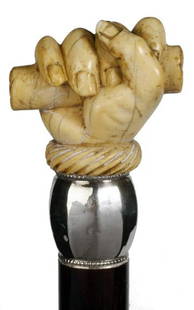 Ivory Fist Cane: Ivory Fist-Circa 1880-A nicely carved fist holding a document with a spiraled ivory cuff, fluted silver collar, rich rosewood shaft and a horn ferrule-H. 2" x 1 ¾", O.L. 35 ¾"-$500-$700
