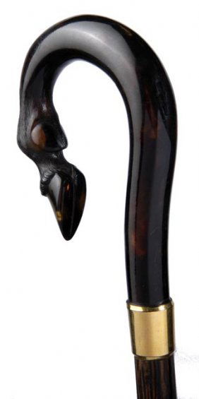 Tortoise shell dress: Tortoiseshell Dress-Circa 1900-A solid tortoise handle which is carved into the shape of a form of a horse's fetlock, gold filled collar, partridgewood shaft and a brass ferrule-H. 3" x 3 ½", O.L. 34