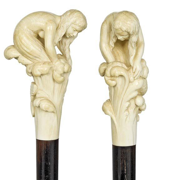 French Art Nouveau Cane: French Art Nouveau - Circa 1890- Carved ivory siren figural handle, ebony shaft and a ivory ferrule. Carved to depict a seductive siren with a long scaled fish tail H-4 ¼" x 2 ½" OL- 34" $1400-$1800