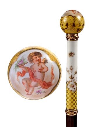 Porcelain Dress Cane-Circa 1890-A dress cane done i: Porcelain Dress Cane-Circa 1890-A dress cane done in the Meissen style, two ornate gold collars, rich exotic wood shaft and a brass ferrule-H. 6" x 6 ½", O.L. 35"-$500-$800