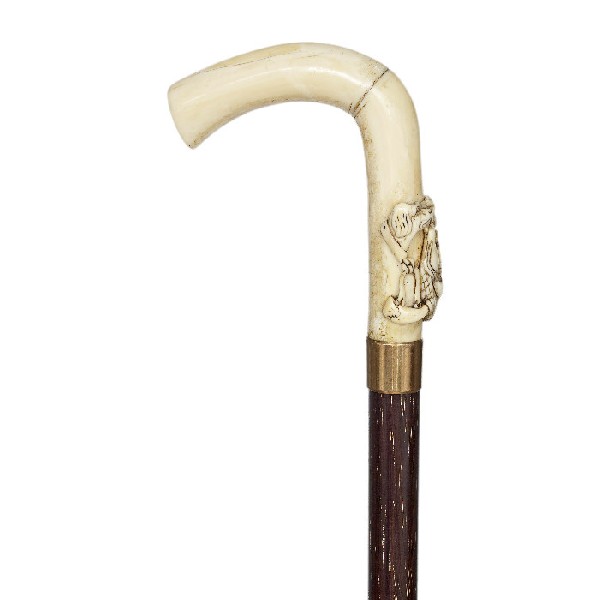 Walrus Ivory Hunting Cane-Circa 1860-Carved ivory h: Walrus Ivory Hunting Cane-Circa 1860-Carved ivory handle, metal collar, rosewood shaft and a horn ferrule. The carving is done in very high relief.-H. 4 ½" x 3 ¾", O.L. 37 ¾"-$600-$1,200