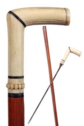 Ivory Sword Cane-Circa 1885-Carved ivory handle wi: Ivory Sword Cane-Circa 1885-Carved ivory handle with baleen spacers, push button mechanism which releases a 12" triangular gilded and blued dagger, malacca shaft and a bone ferrule-H. 3 ¼" x 2 ¼", O