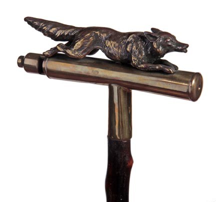 Fox Whistle Cane-Circa 1930-An unusual brass whist: Fox Whistle Cane-Circa 1930-An unusual brass whistle cane with a full figured fox, natural twig spur shaft and a bi-metal ferrule, James Semones Collection-H. 6 ½" x 3 ½", O.L. 35"-$500-$800
