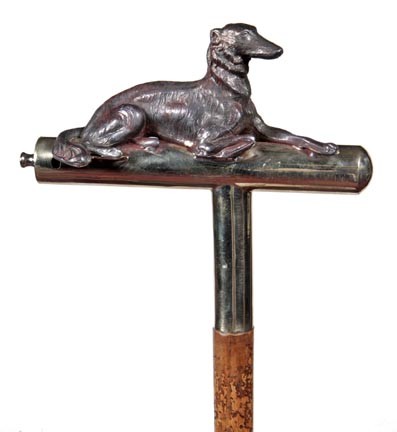 Whippet Whistle Cane-20th Century-An early dog whi: Whippet Whistle Cane-20th Century-An early dog whistle handle which has a metal dog attached, malacca shaft, James Semones Collection and a 3 ½" brass- ferrule- H. 7 ½" x 6 ½", O.L. 36"-$500-$800