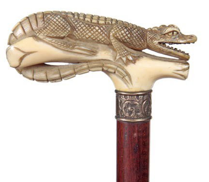 Ivory Alligator Cane-Circa 1900-A full figure ivor: Ivory Alligator Cane-Circa 1900-A full figure ivory alligator, very ornate gold-filled collar, exotic wood shaft and a bi-metal ferrule, James Semones Collection-H. 4" x 1 ¾", O.L. 36"-$500-$1,000