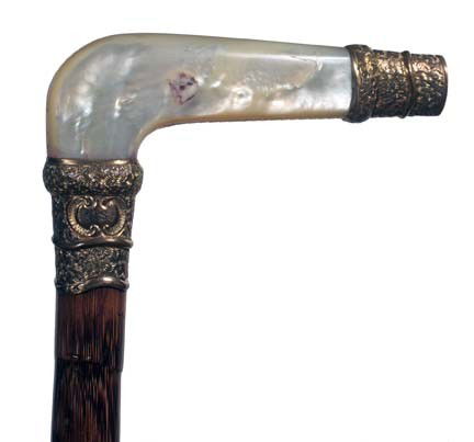 M.O.P. Dress Cane-Ca. 1880-A nice stylized handle: M.O.P. Dress Cane-Ca. 1880-A nice stylized handle with an ornate gold filled end cap and collar, faux bamboo, partridge shaft and a brass ferrule-H. 4 ¼" x 1 ½", O.L. 36"-$400-$600