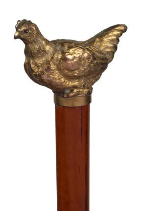 Chicken Dress Cane-Early 20th Century-A finely cast: Chicken Dress Cane-Early 20th Century-A finely cast gold plated chicken with ruby colored eyes, nice malacca shaft and a metal ferrule-H. 2 ¼" x 1 ½", O.L. 35 ½"-$300-$500