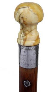 Whale's Tooth Presentation Cane-Dated 1869-Carved: 125 Whale’s Tooth Presentation Cane-Dated 1869-Carved whale’s tooth handle, large silver presentation collar, filled coin silver lanyard holes, American oak shaft and a 4" brass ferrule. (small