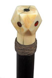 Whale's Tooth Dice Cane-Circa 1875-A polyhedron ca: Whale's Tooth Dice Cane-Circa 1875-A polyhedron carved handle with ceiling wax inserts, nautical woven metal collar, ebony shaft and a brass ferrule-H. 1 ¼" x 1 ¾", O.L. 36 ½"-$600-$900