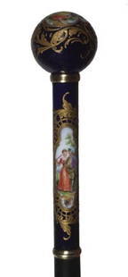 Porcelain Dress Cane-Circa 1900-A mint example of: Porcelain Dress Cane-Circa 1900-A mint example of a porcelain scenic cobalt dress cane, heavy Moriage work throughout, two gold metal collars, ebony shaft and a metal ferrule-H. 1 ½" x 5 ¼", O.L.