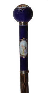 Large Porcelain Dress Cane-Circa 1900-A cobalt dec: Large Porcelain Dress Cane-Circa 1900-A cobalt decorated portrait cane, two gold metal collars, ribbed partridge wood shaft and a metal ferrule-H. 1 ¾" x 5 ½", O.L. 36"-$700-$900