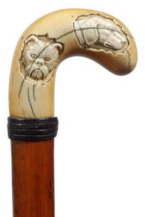 Ivory Dog Cane-Early 20th Century-A carved ivory h: Ivory Dog Cane-Early 20th Century-A carved ivory handle with three dogs, woven leather collar, rich Malacca shaft and a metal ferrule-H. 3" x 2 ½", O.L. 34 ½"-$600-$800