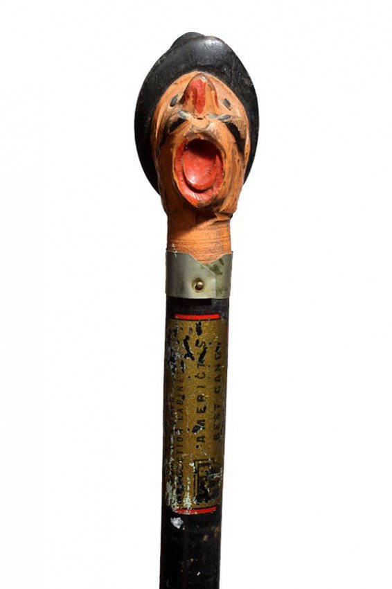 Advertising Candy Company Cane: A carved and painted handle with partial decal still remaining wood shaft and a rubber stopper-O.L. 36"-Circa 1930