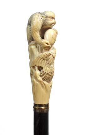 Japanese Ivory Dress Cane-Circa 1890-A large carved: Japanese Ivory Dress Cane-Circa 1890-A large carved ivory handle with a ape steeling an egg from a mother eagle, brass collar, ebony shaft and a horn ferrule-H. 4 ½" x 1 ¾", O.L. 36 ½"-$1,000-$1,50