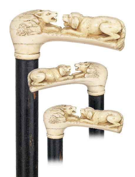 Barking Ivory Dogs Cane-Late 19th Century-A unique : Barking Ivory Dogs Cane-Late 19th Century-A unique ivory cane carved in high relief with two facing dogs barking at one another, ebonized wood and a metal ferrule. Great surface luminosity-H. 4 ½" x 