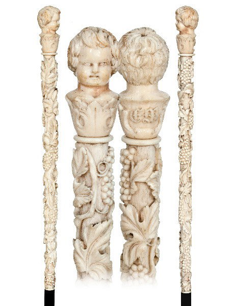 Wine Allegory Ivory French Cane-Late19th Century-A: Wine Allegory Ivory French Cane-Late19th Century-A long ivory handle fine and deeply carved with an encircling vine with grapes and leaves and topped by a male bust with initials. Ebony shaft and an i