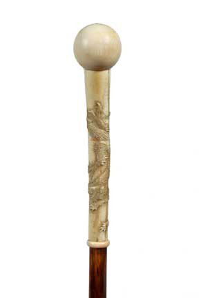 Asian Ivory Dress Cane-Circa 1890-Carved ivory dra: Asian Ivory Dress Cane-Circa 1890-Carved ivory dragon handle, ivory ball atop, ivory collar, exotic wood shaft and an ivory ferrule-H. 6”x 1 ¼”, O.L. 35 ¾”-$400-$600
