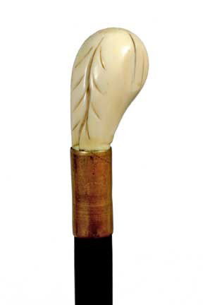 Ivory Dress Cane-Circa 1890-A walrus ivory handle: Ivory Dress Cane-Circa 1890-A walrus ivory handle with a tree leaf design, brass collar, ebony shaft and no ferrule-H. 2 ½" x 1 ½", O.L. 34 ½"-$200-$250