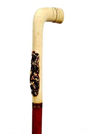 Ivory Dress Cane-Circa 1880-A bushy tailed squirre: Ivory Dress Cane-Circa 1880-A bushy tailed squirrel done in high relief, small brass collar, malacca shaft and a metal ferrule-H. 2 ½" x 5", O.L. 32 ¾"-$300-$400