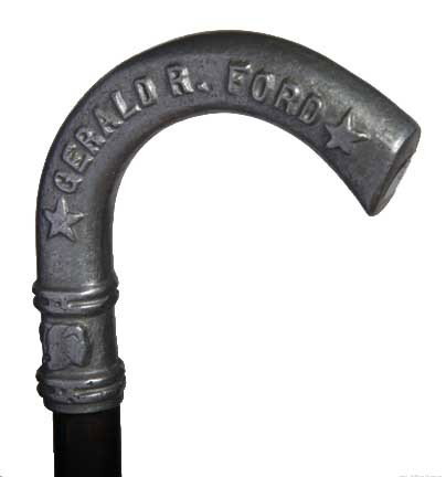 Gerald Ford Political Cane: Circa 1976-A pewter crook handle cane which was used in the campaign of Gerald Ford for President of the United States, hardwood shaft and no ferrule, in fine condition-H. 4 1/2" x 4", O.L. 35"