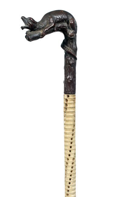 Antique cane Black Forrest Carving: 66. A Circa 1880 black forest 4 ¼" x 5 ¼" fantasy animal, vertebra stacked shaft, 36" O.L., metal ferrule-$300-$500